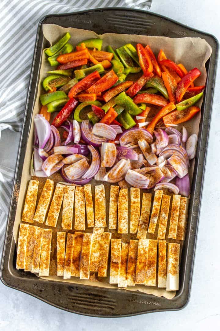 sliced tofu onion and bell pepper on a sheet pan