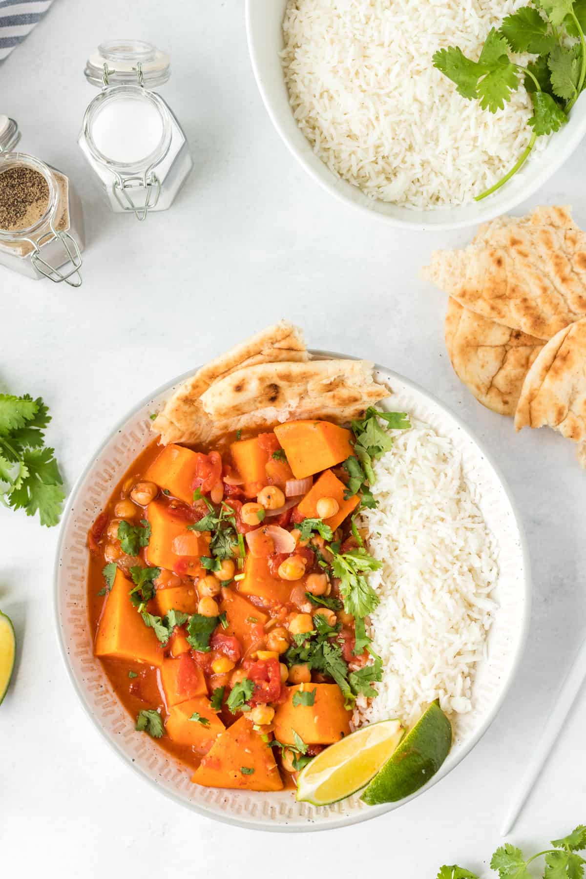 Sweet Potato Chickpea Stew serve in bowl with rice and naan bread 