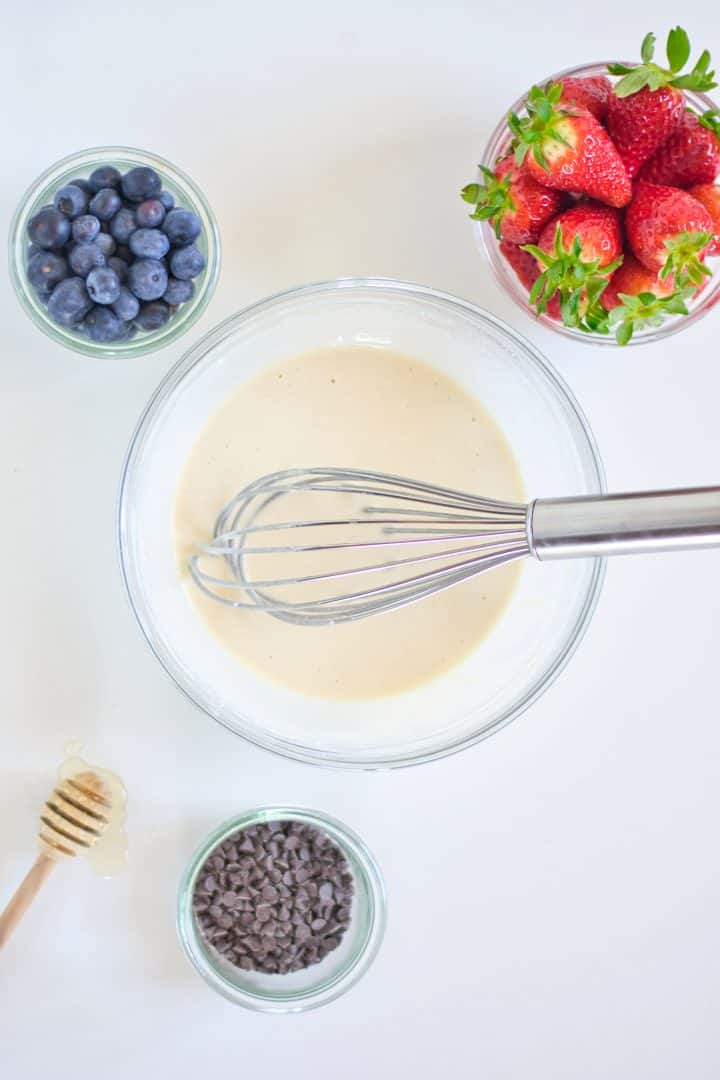 Mixing milk with flour in a bowl