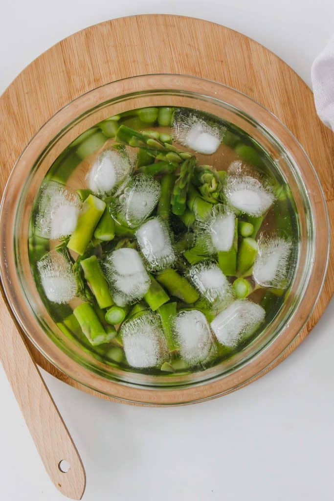 asparagus in a bowl with ice 