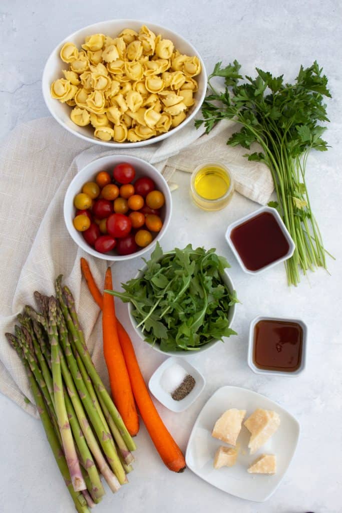ingredients you need to make this recipe, carrot, asparagus, parmesan cheese, arugula, tortellini, parsley, and tomatoes