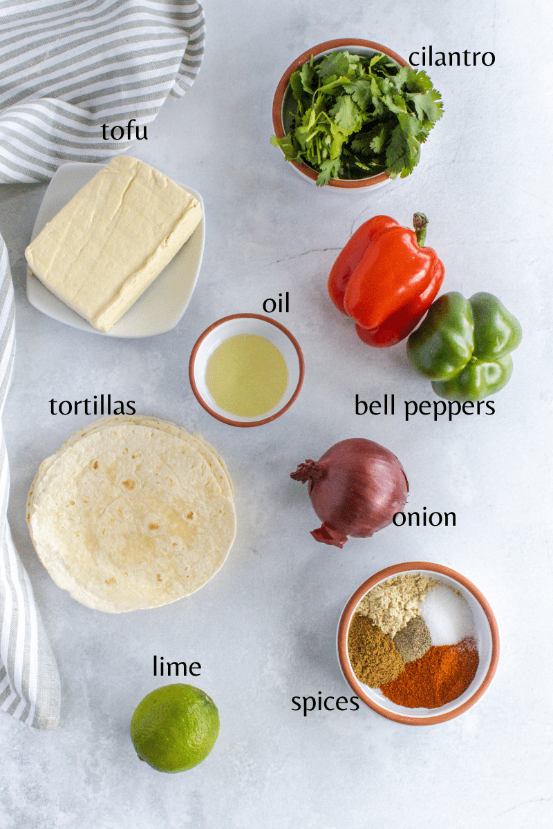 ingrdients to make the tofu fajitas, tofu, tortillas, cilantro, bell pepper, onion, Mexican spices