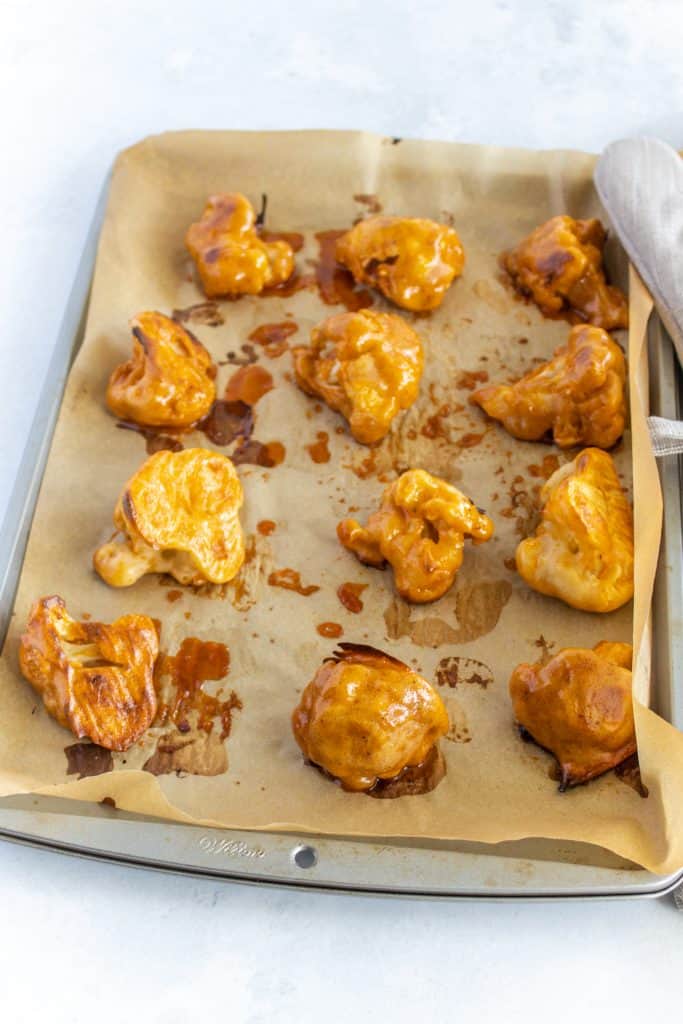 cooked wings coming out of the oven