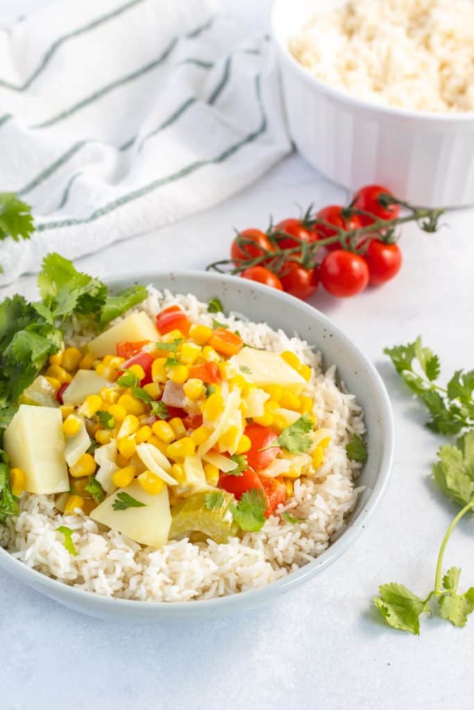 Corn chowder in a bowl over rice