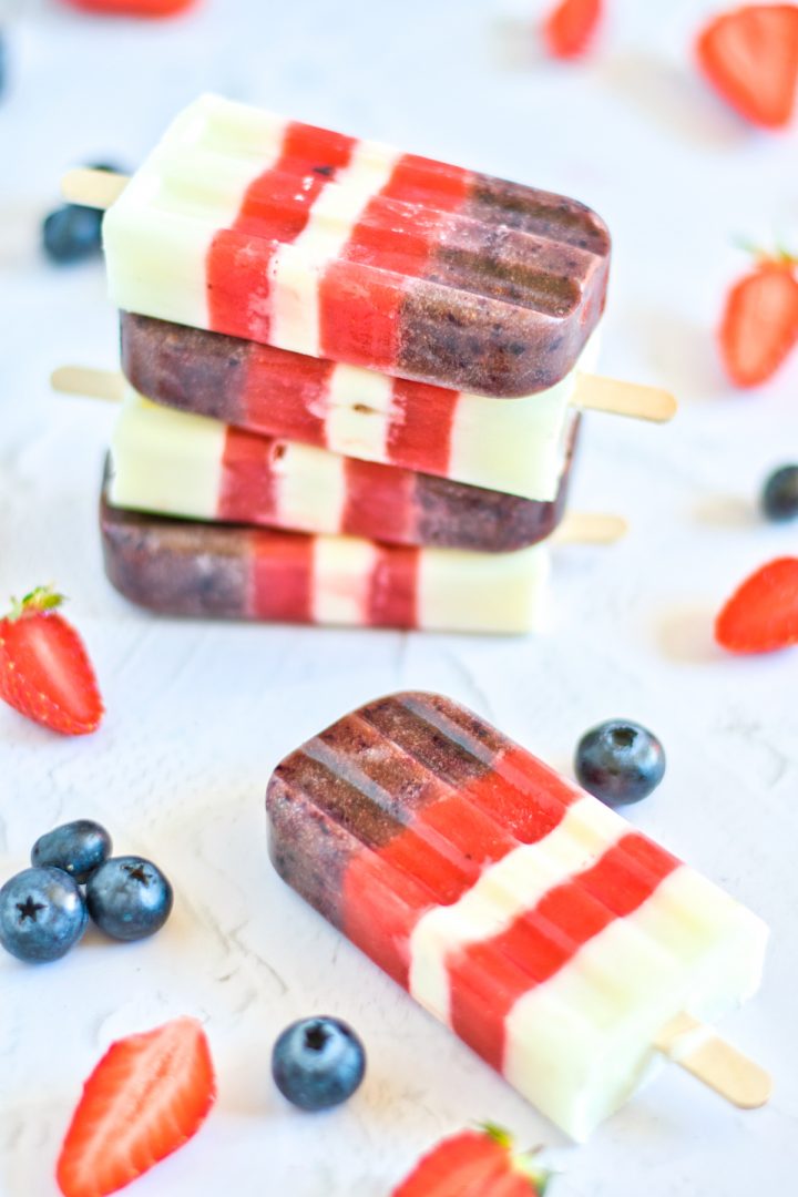  4 berries popsicles on top of each others 