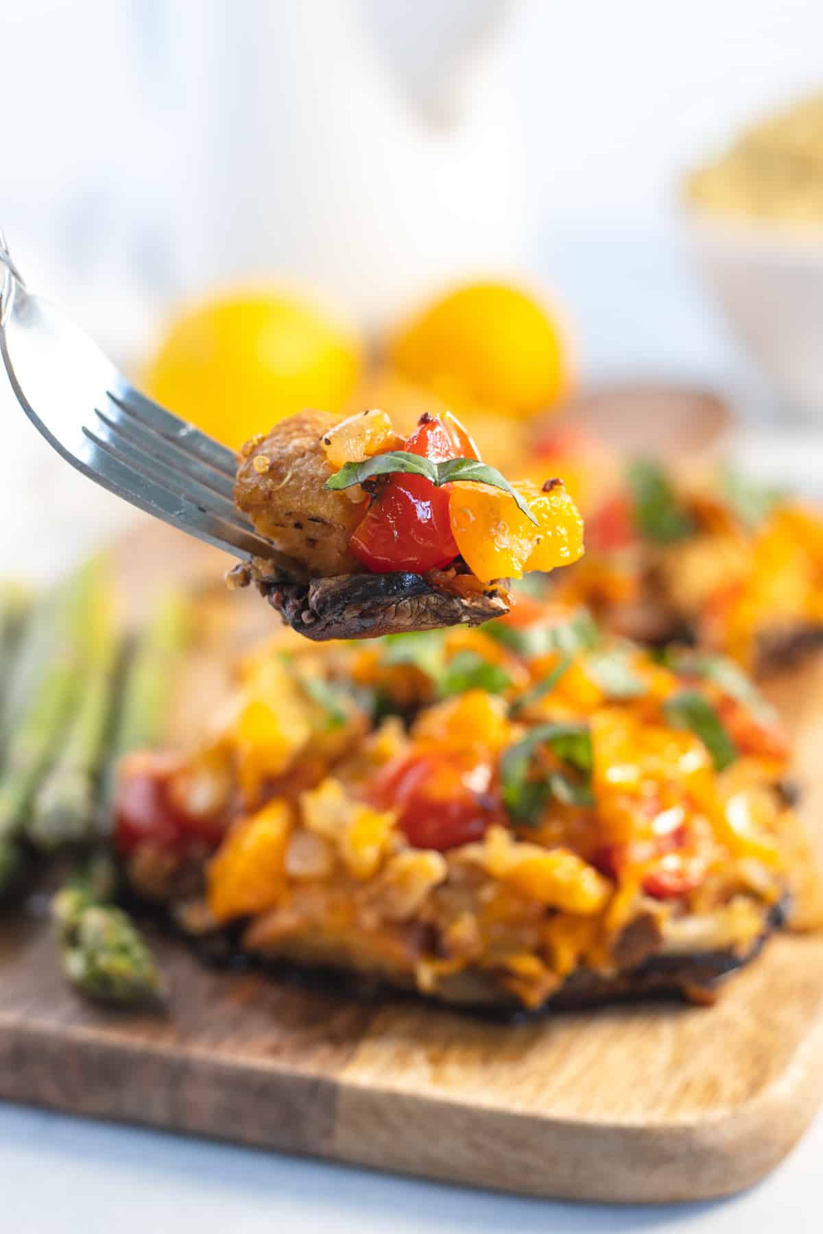 Fork with a bite of the stuffed portobello mushroom 