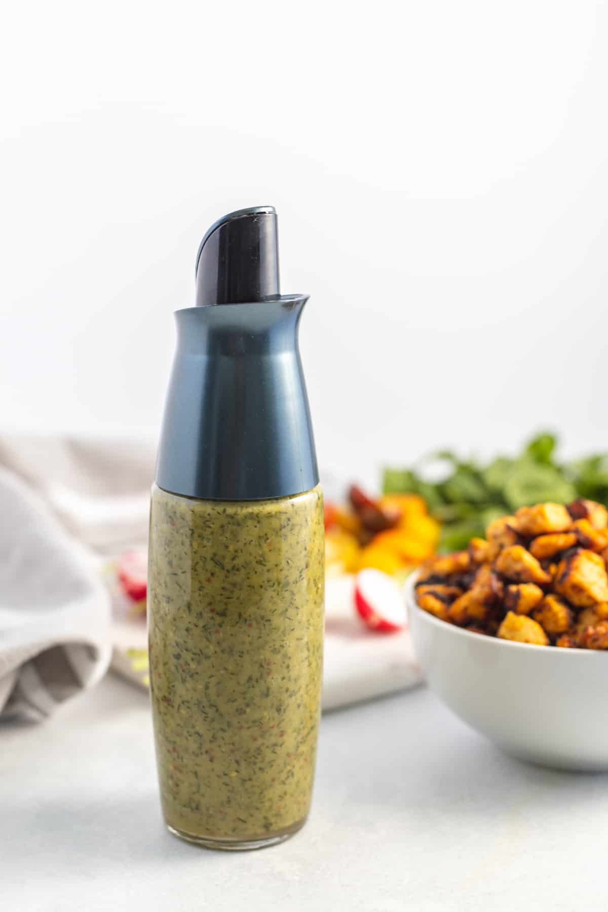 Fresh herd vinaigrette on a glass container on the table