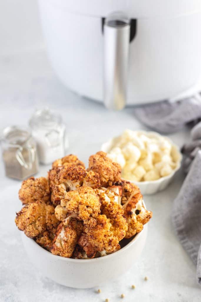 Cauliflower floret with Harissa sauce in a white bowl 