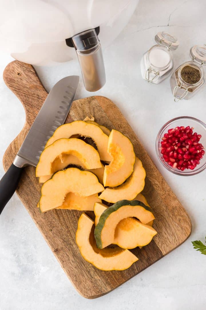 Slice acorn squash on a cutting board