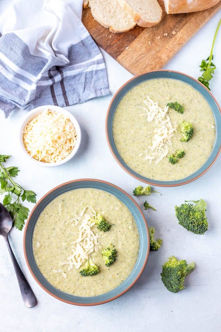 Broccoli and cheese soup serve in bowl in broccoli florets on the side