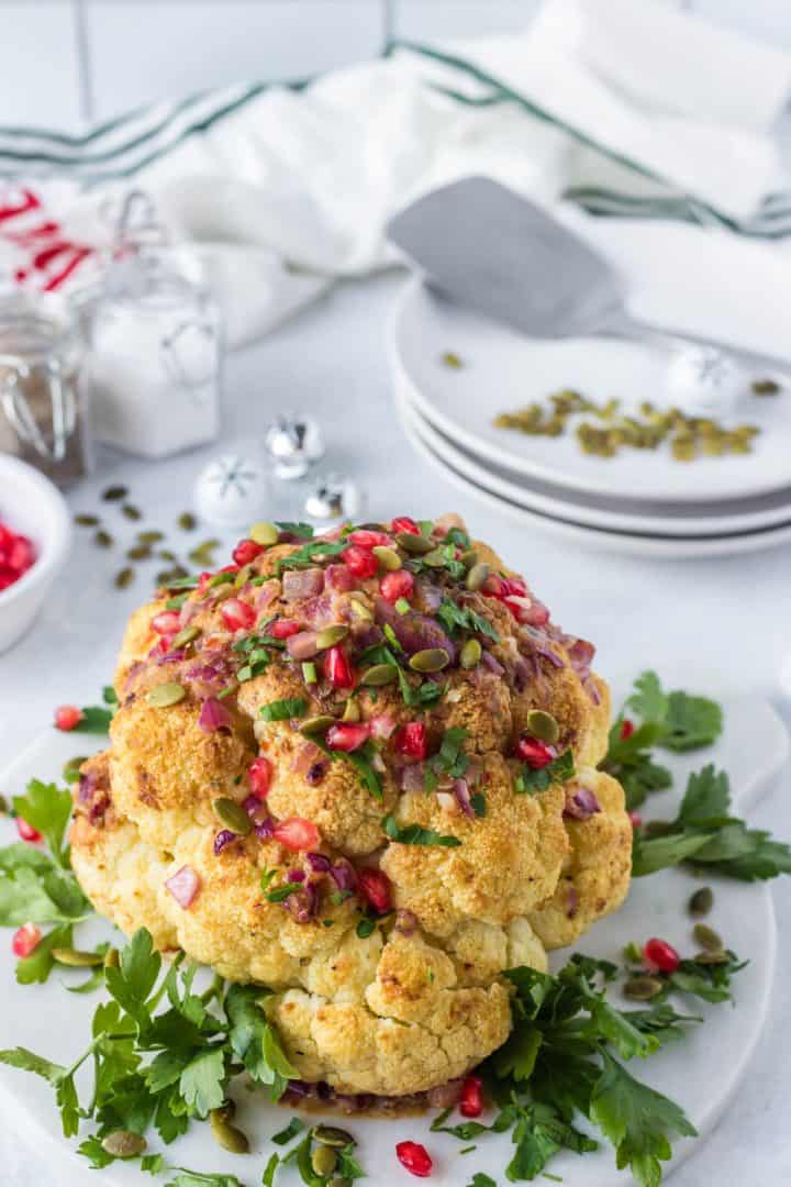White Wine and Pomegranate Whole Roasted Cauliflower in a serving plate