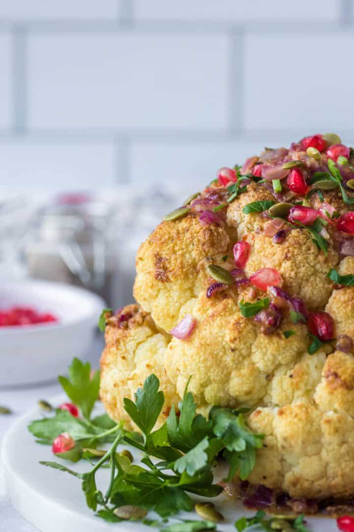 Whole Roasted Cauliflower tin a serving plate close up