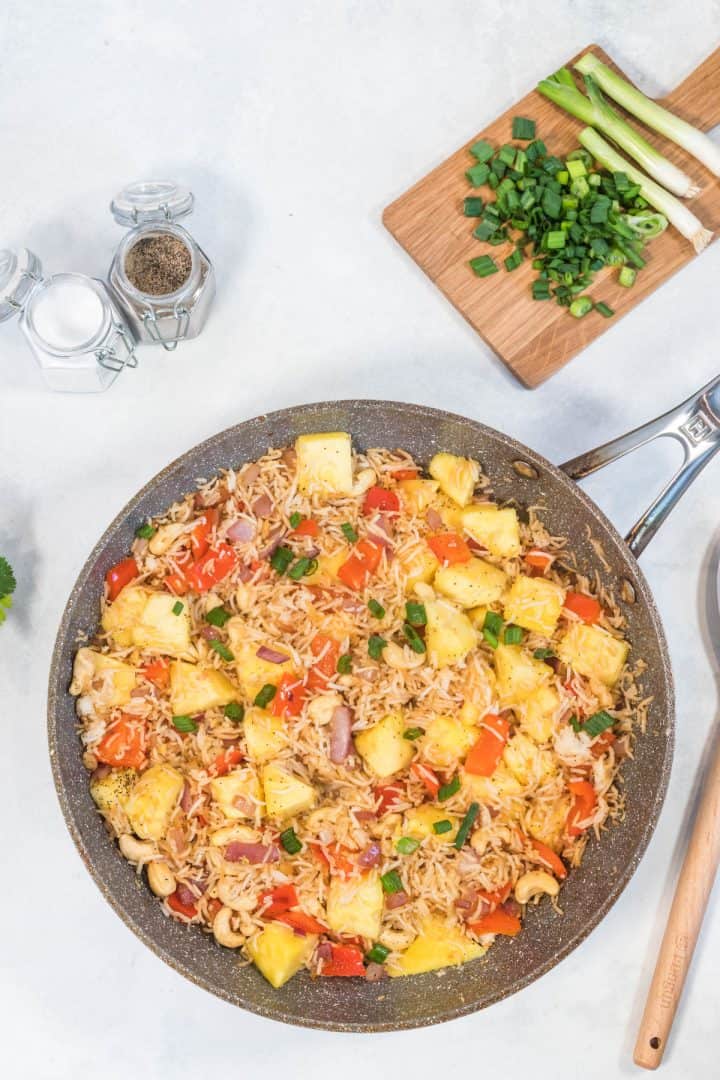 pineapple rice with all the ingredients in a large saucepan