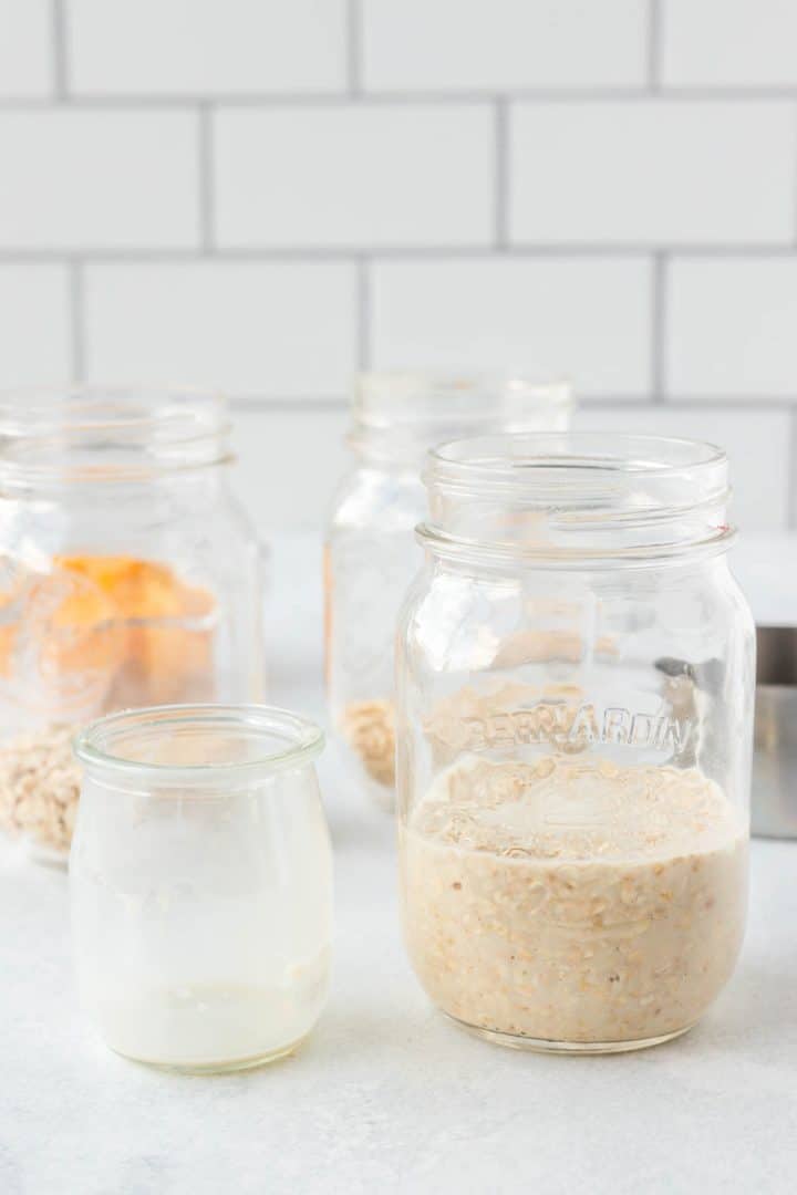 Adding the milk to the mason jar with the oats