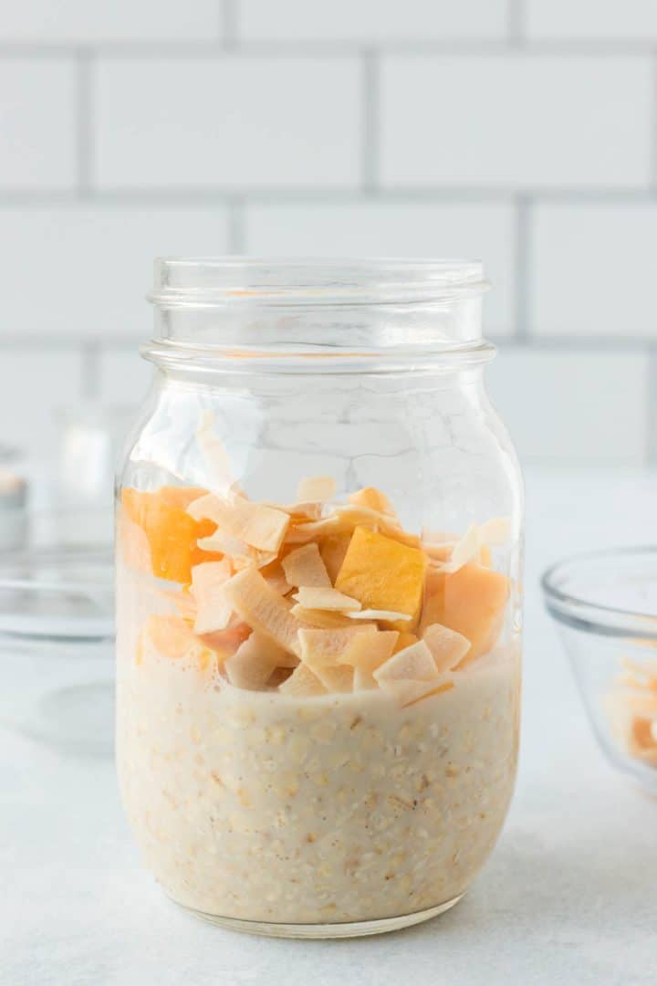 Adding the mango and coconut on top of the oats