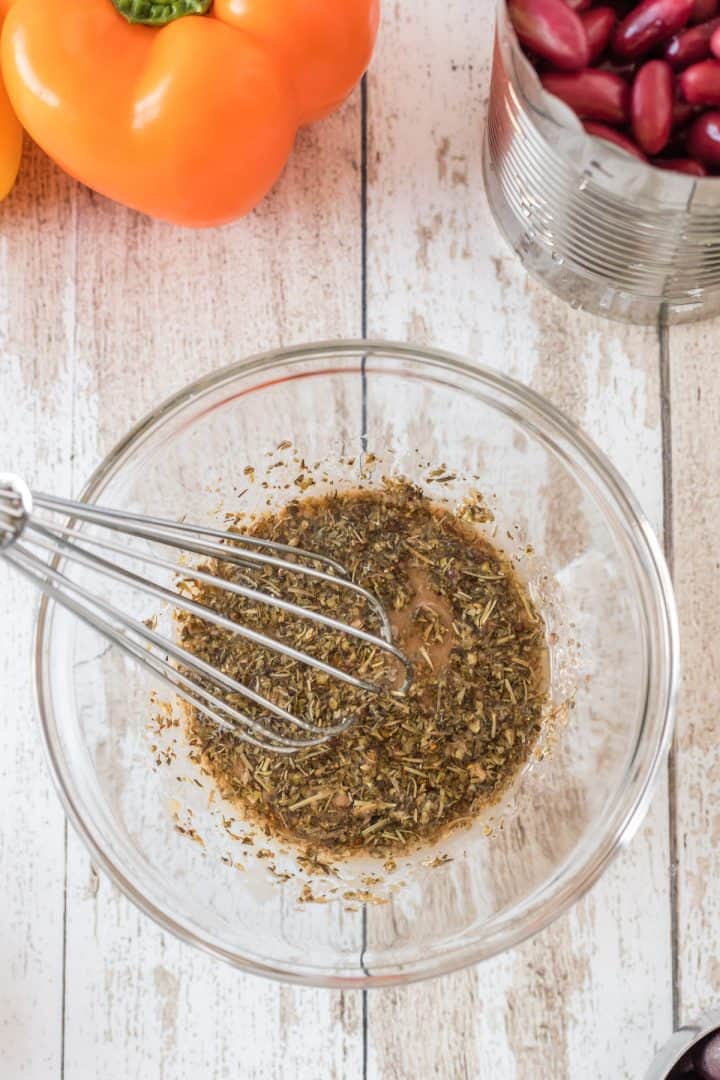 Making the dressing in a bowl with wisk