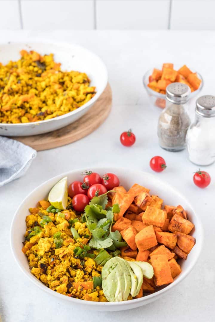 Southwest Tofu Scramble in a bowl with roasted sweet potatoes