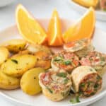 Egg bites in a plate with potatoes and oranges slices. close up