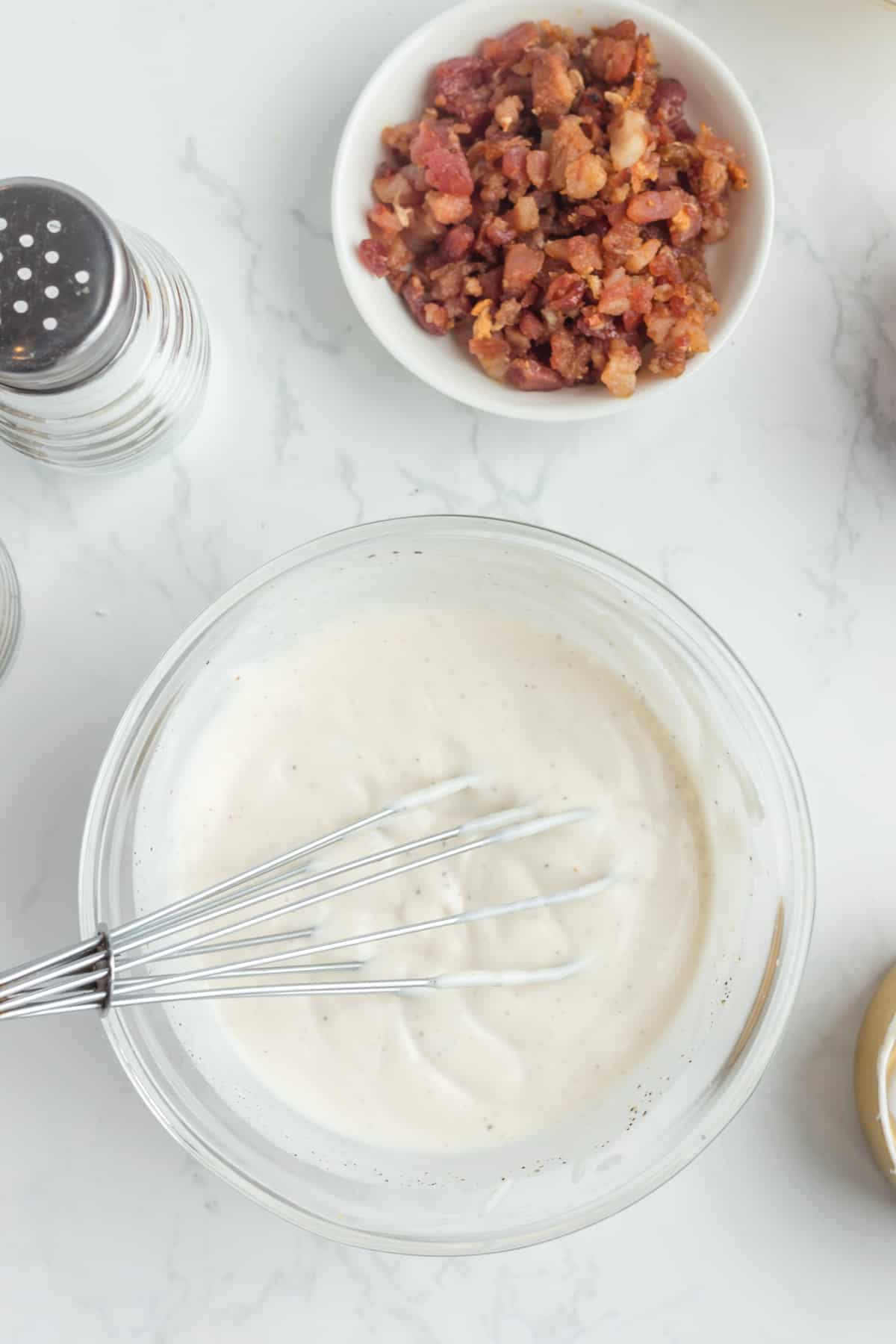 Mixing the the ingredients for the dressing with a wisk.