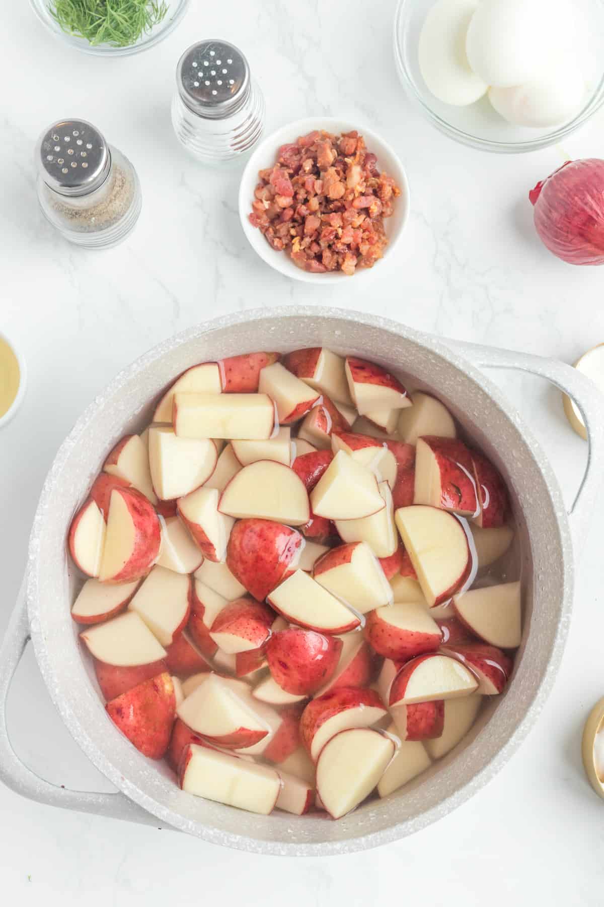 potato ready to be cooked in a pot with water.