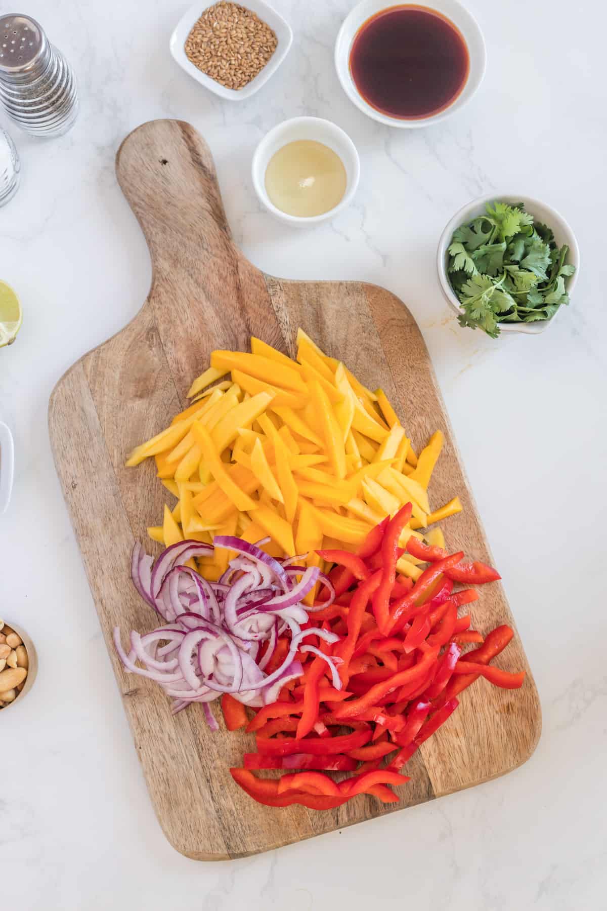 mango, bell pepper, and onion on a cutting board