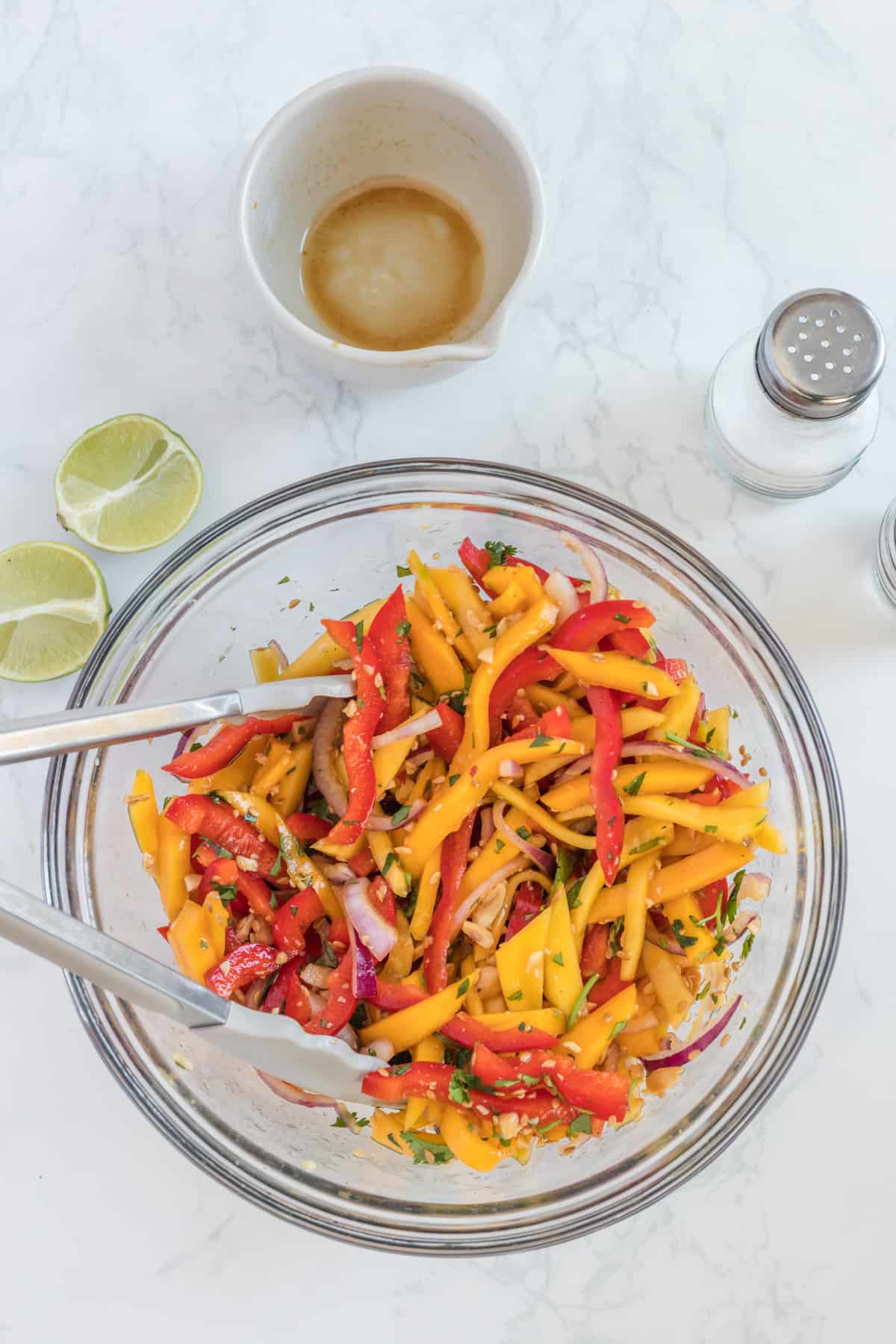 mixing the salad with the dressing.