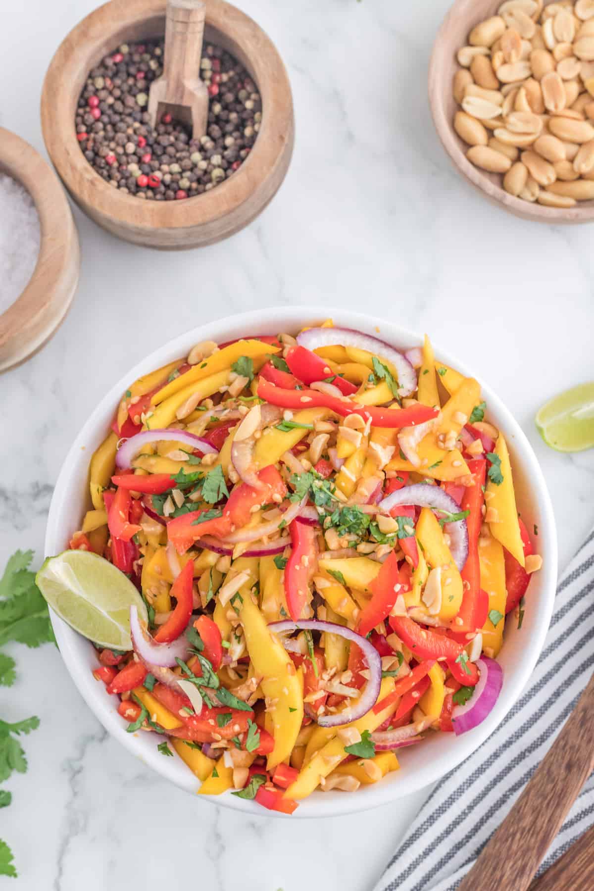 Thai mango salad in a serving bowl, top view.