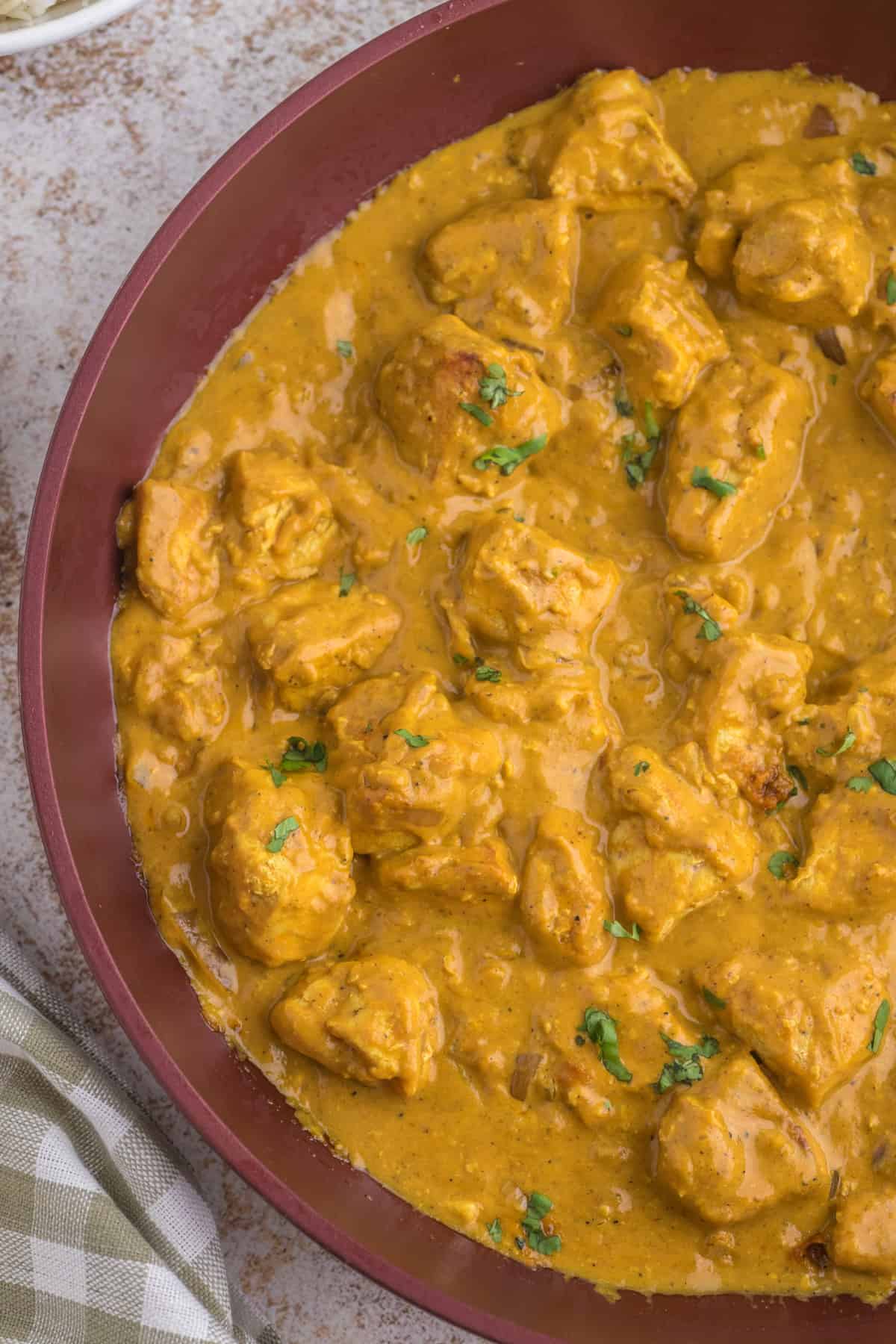 Butter Chicken Pumpkin Curry in a skillet close up.