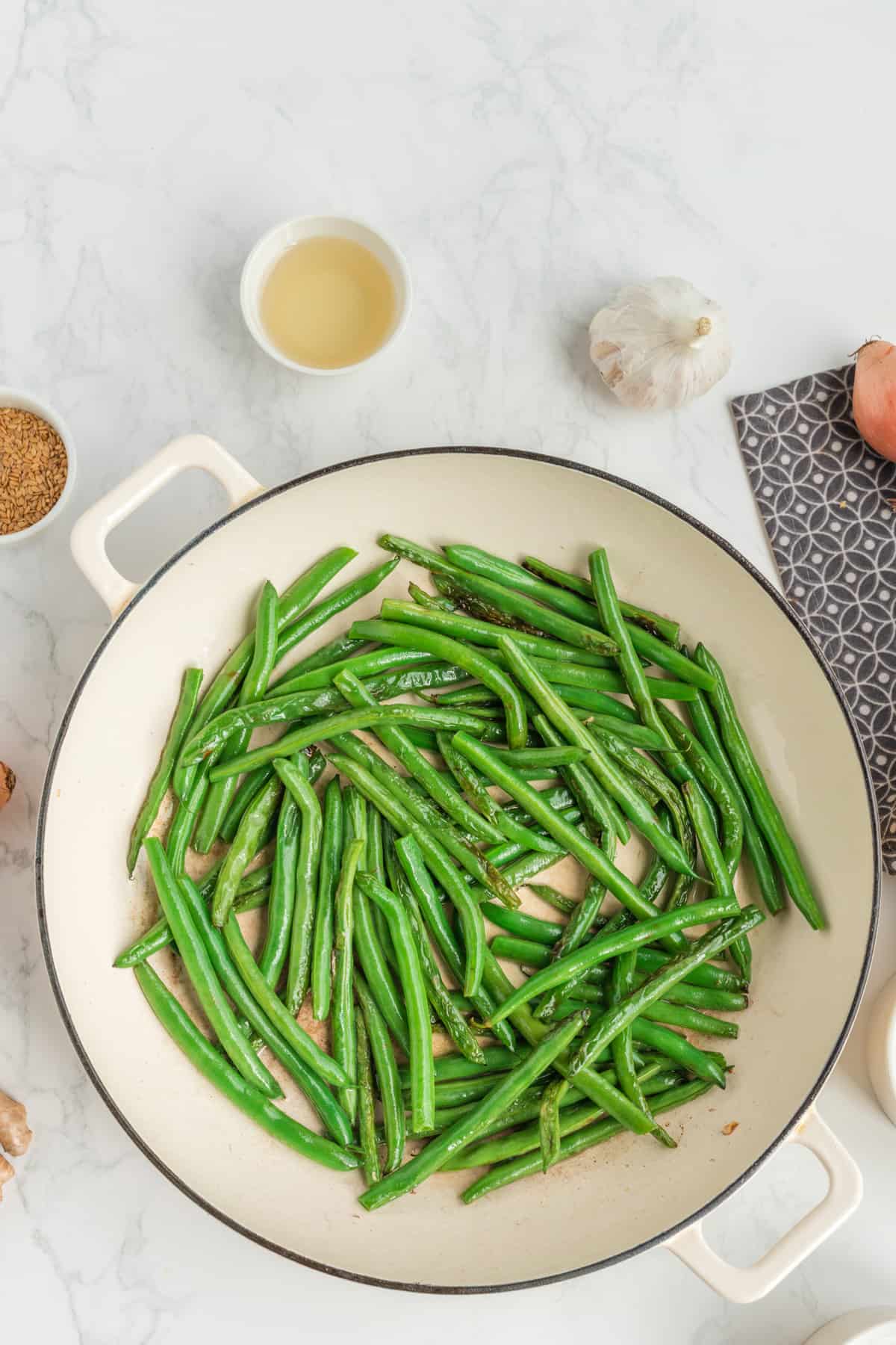 Cooked Green beans in the skillet.