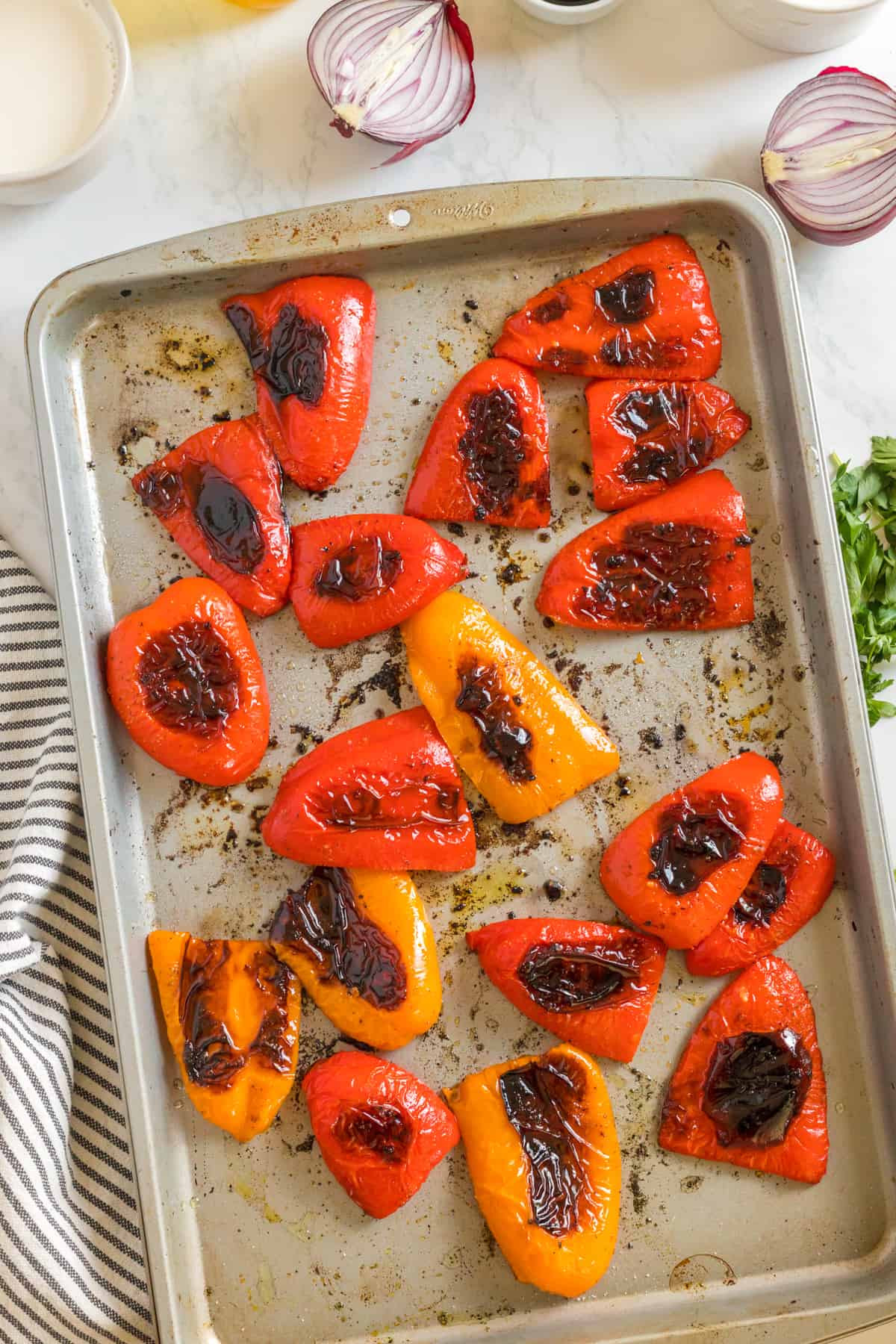 Bell peppers out of the oven, on a baking sheet.