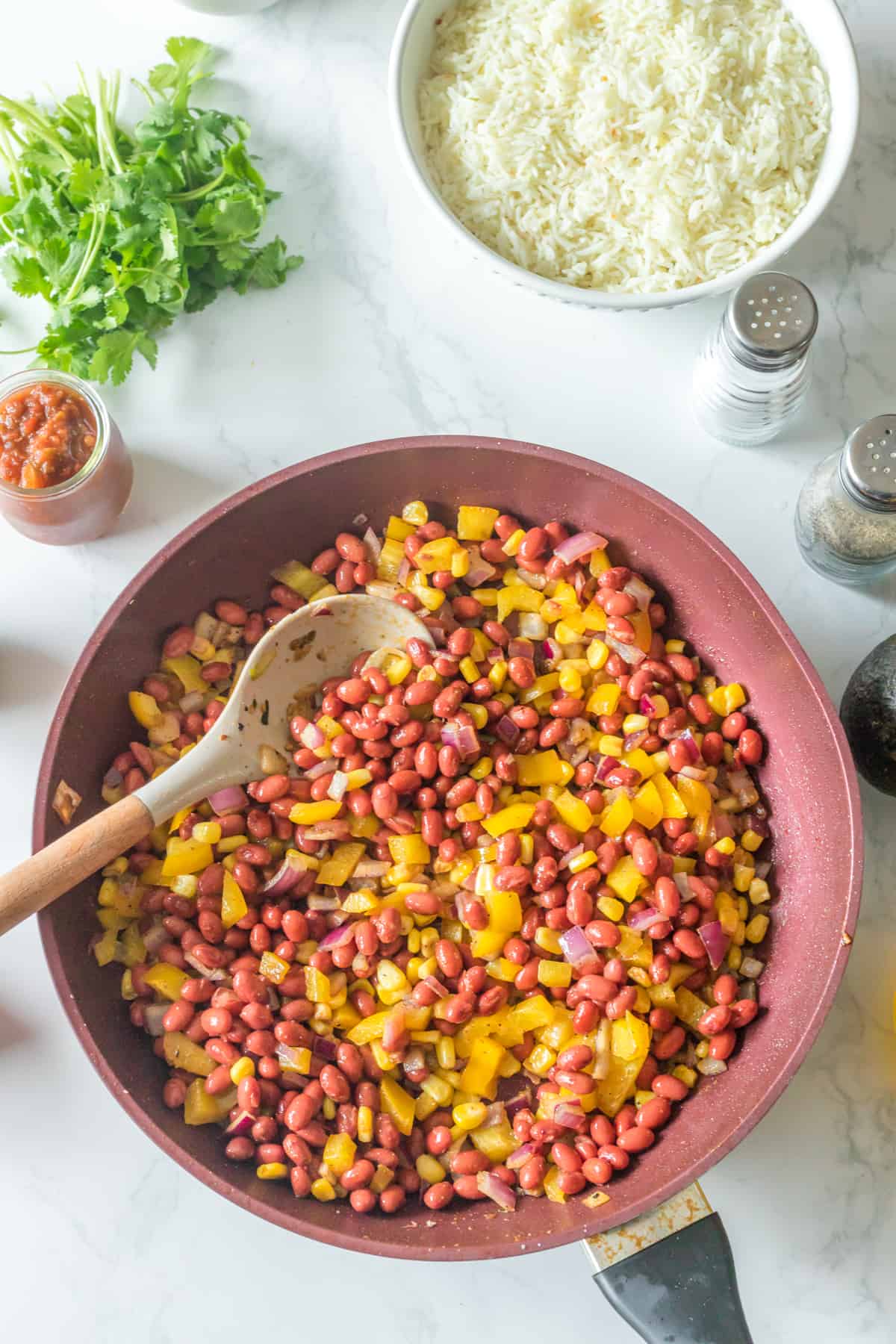 BELL PEPPER, ONION, KIDNEY BEAN AND CORN COOKED IN A PAN.