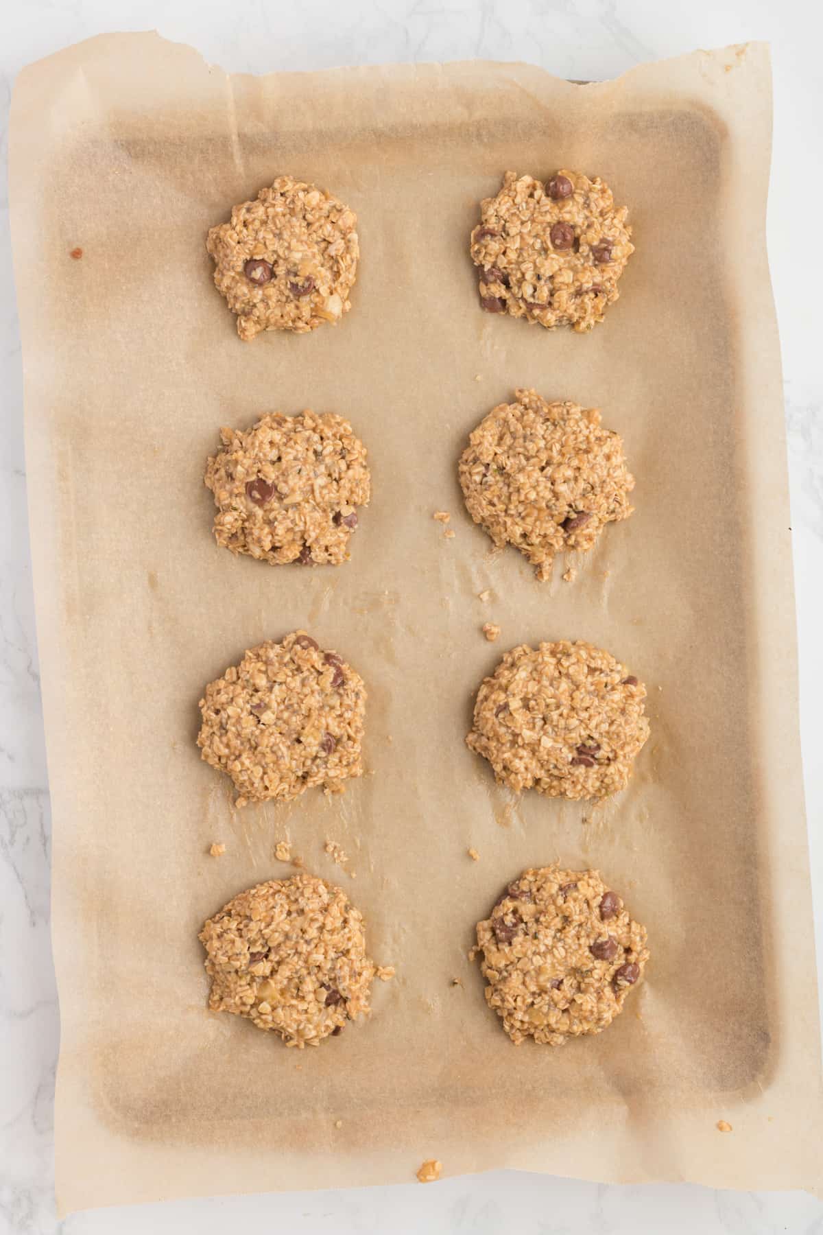 Cookies uncooked on a cookie sheet ready to be baked.