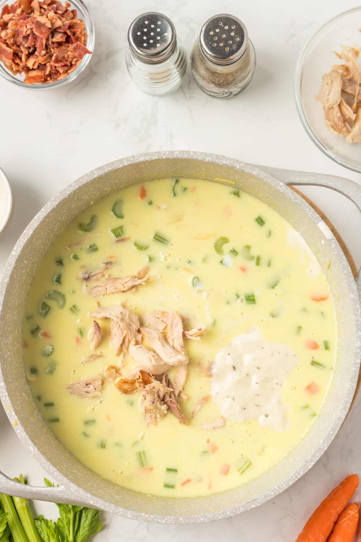 Adding the chicken and ranch dressing to the pot.