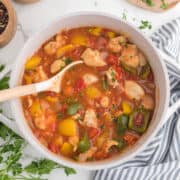 Goulash in a pot with a serving spoon.