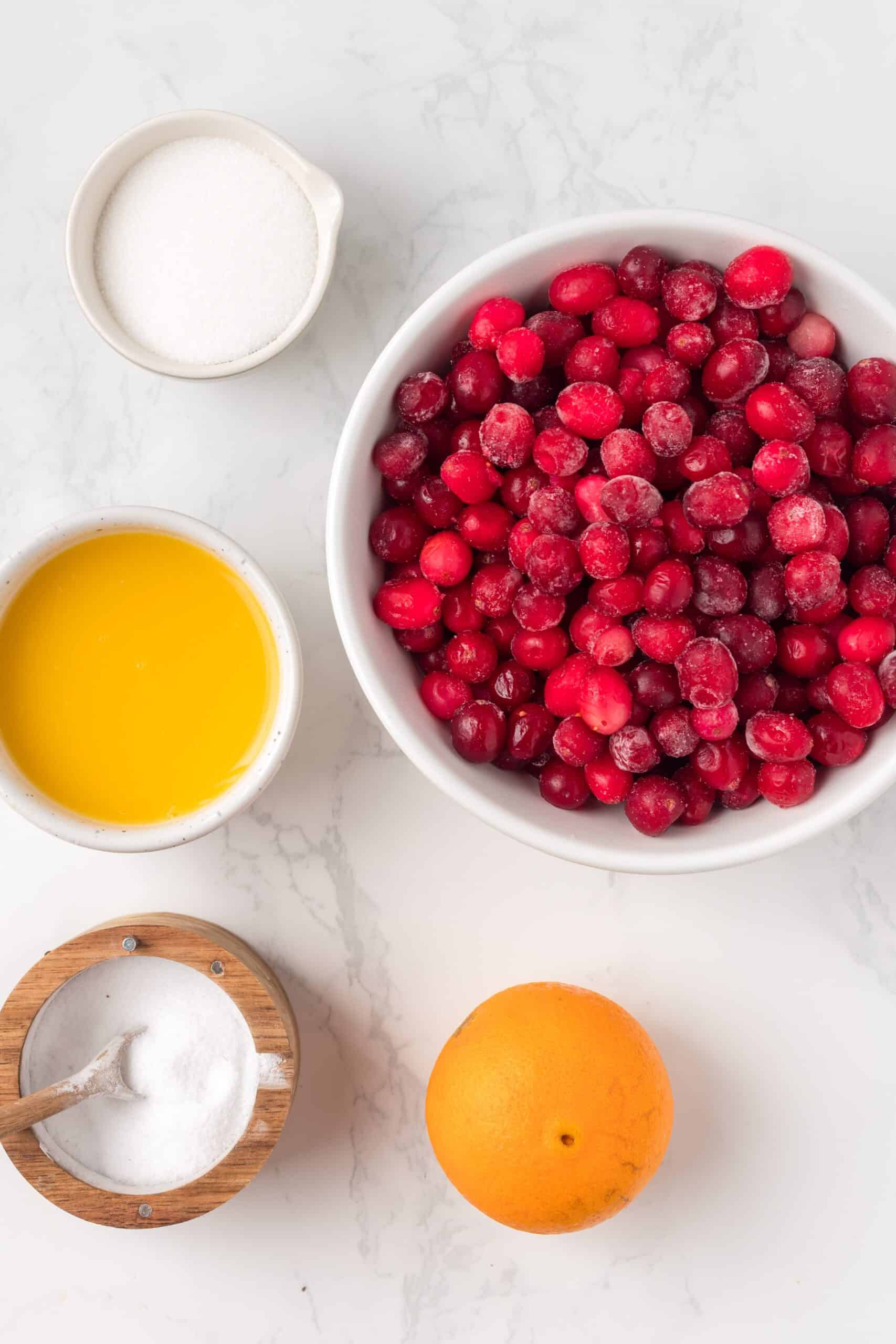 ingredients you need to make the cranberry sauce on a white background.