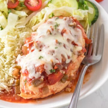 Chicken serve in a plate with a fork.