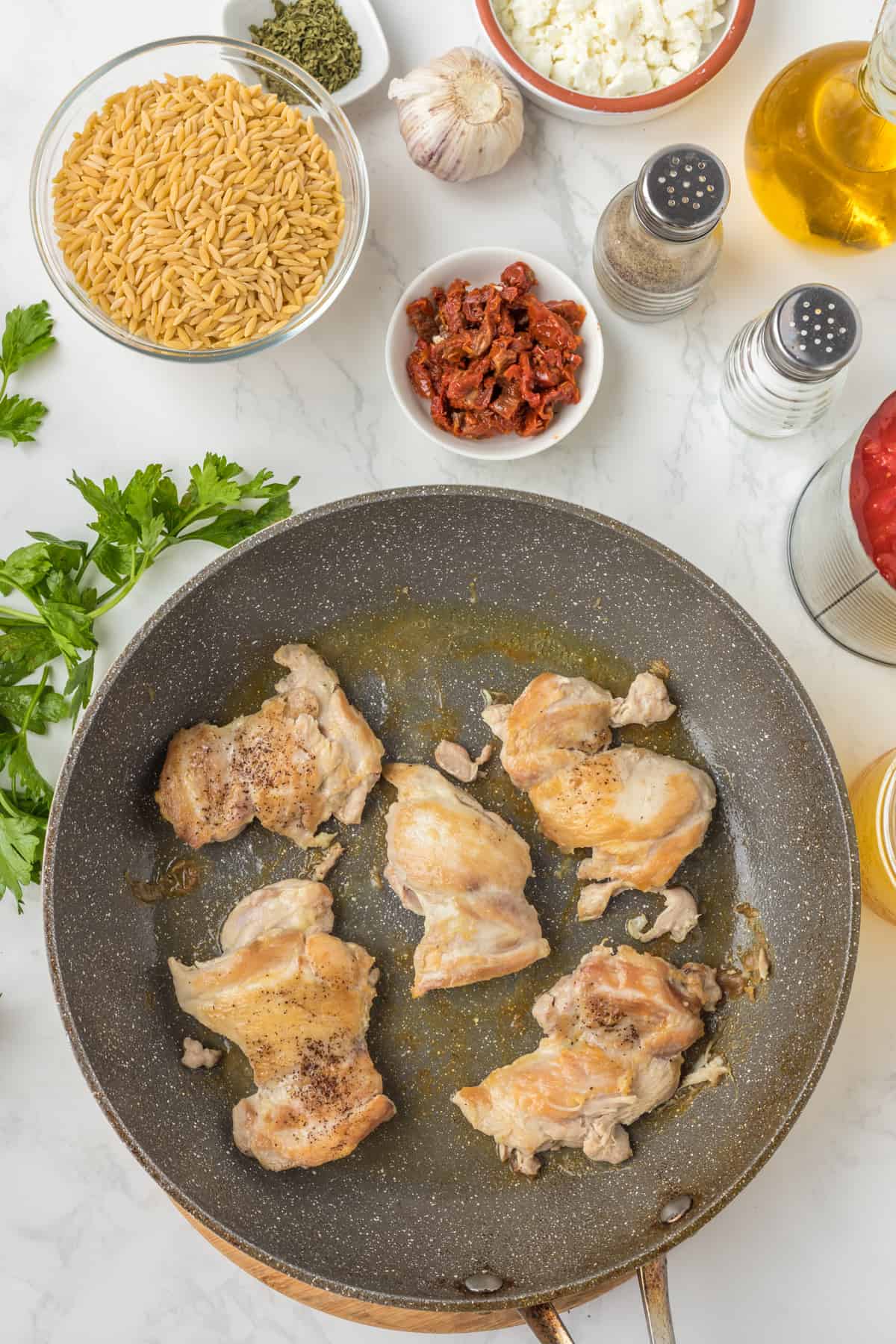 Chicken cooking in the skillet.