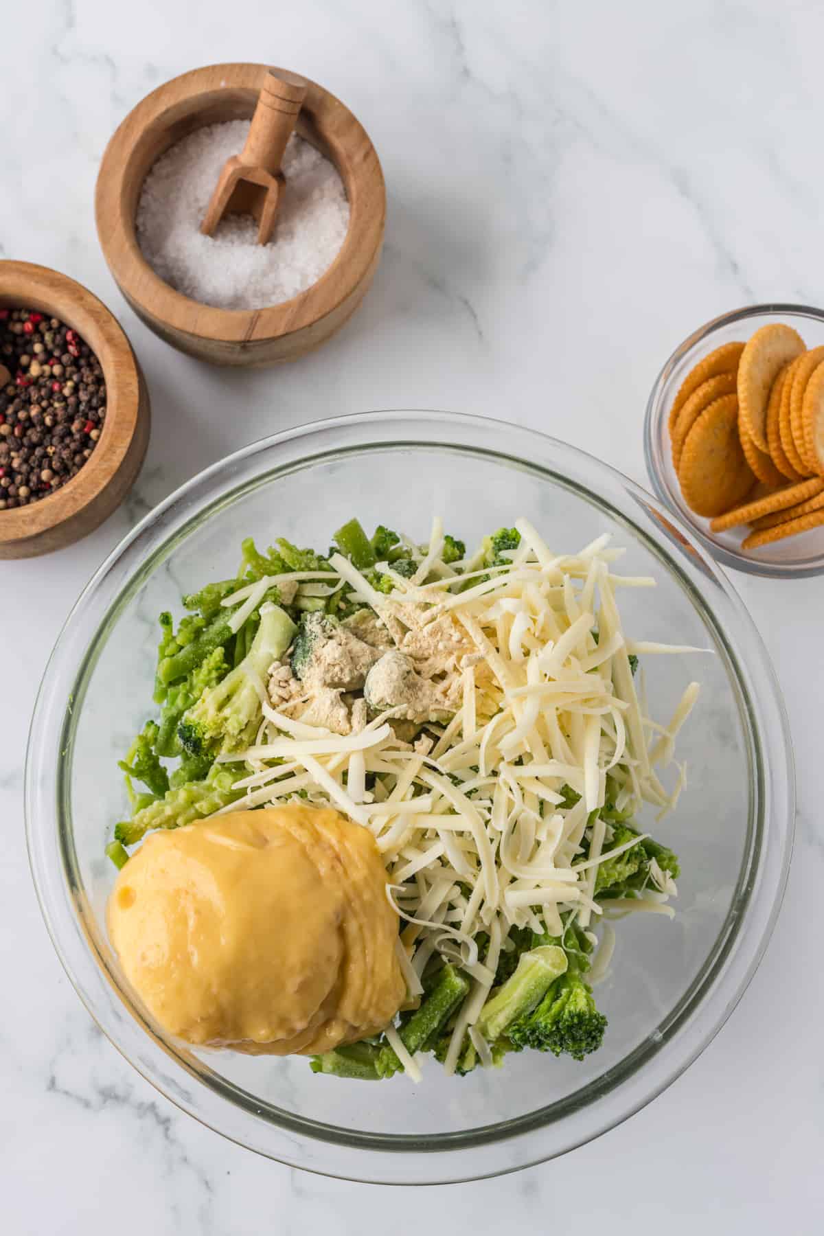 Broccoli, cheese, and soup in a bowl ready to be mix.