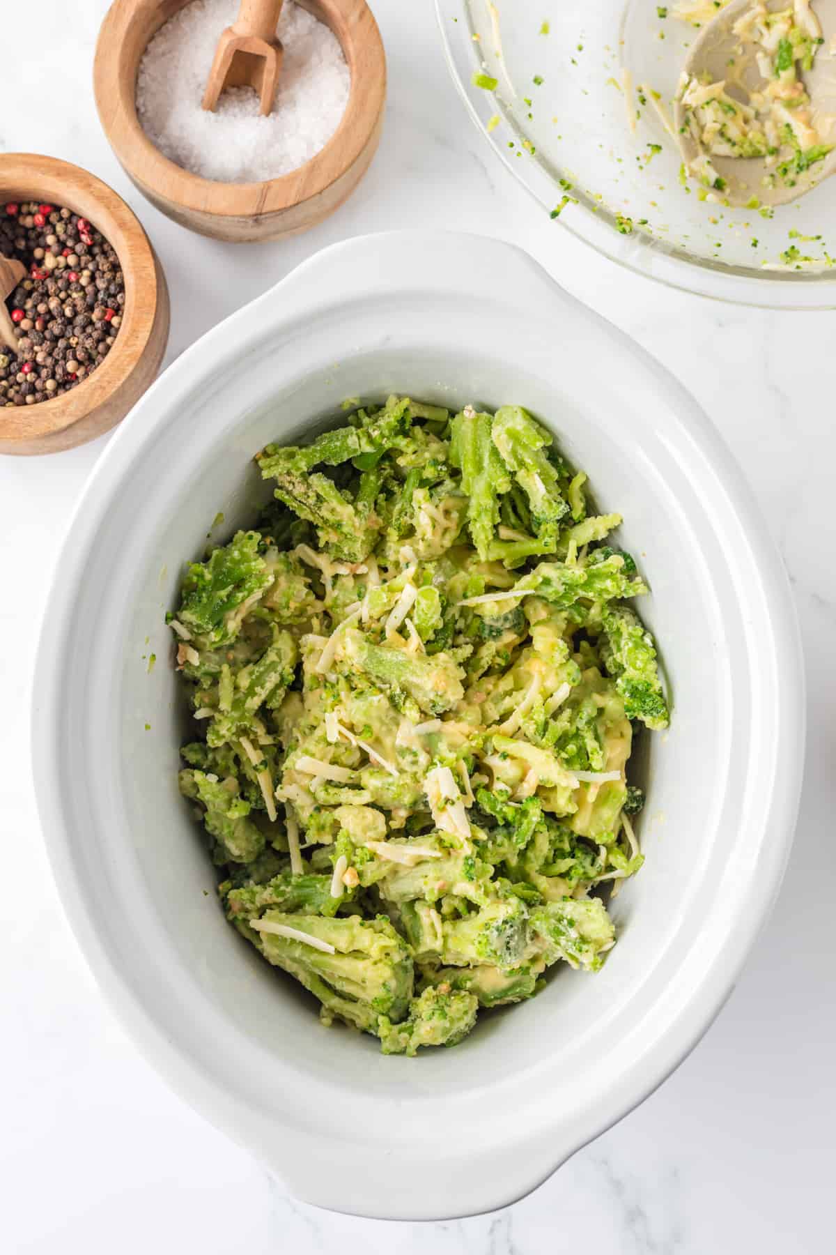 Adding the broccoli to the crockpot.