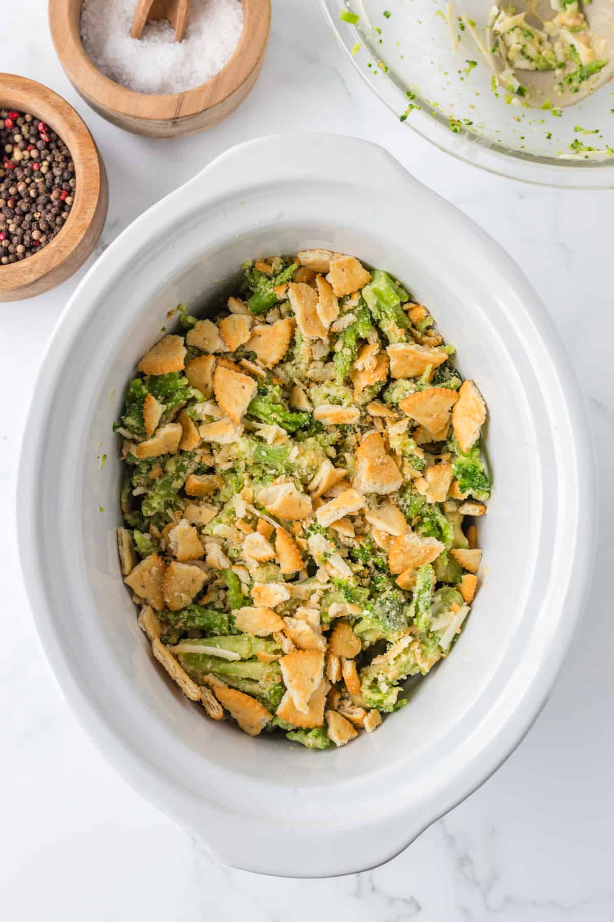 adding the ritz crackers to the broccoli casserole.