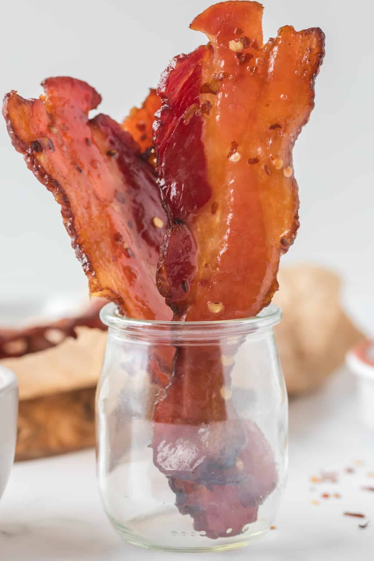 Bacon cooked in a glass jar.