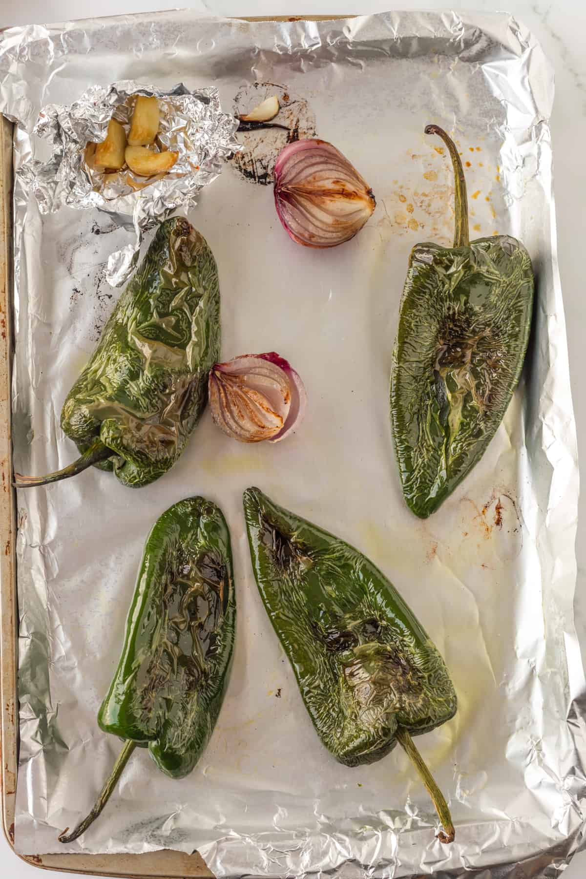 pepper, onion, and garlic on a sheet pan cooked.