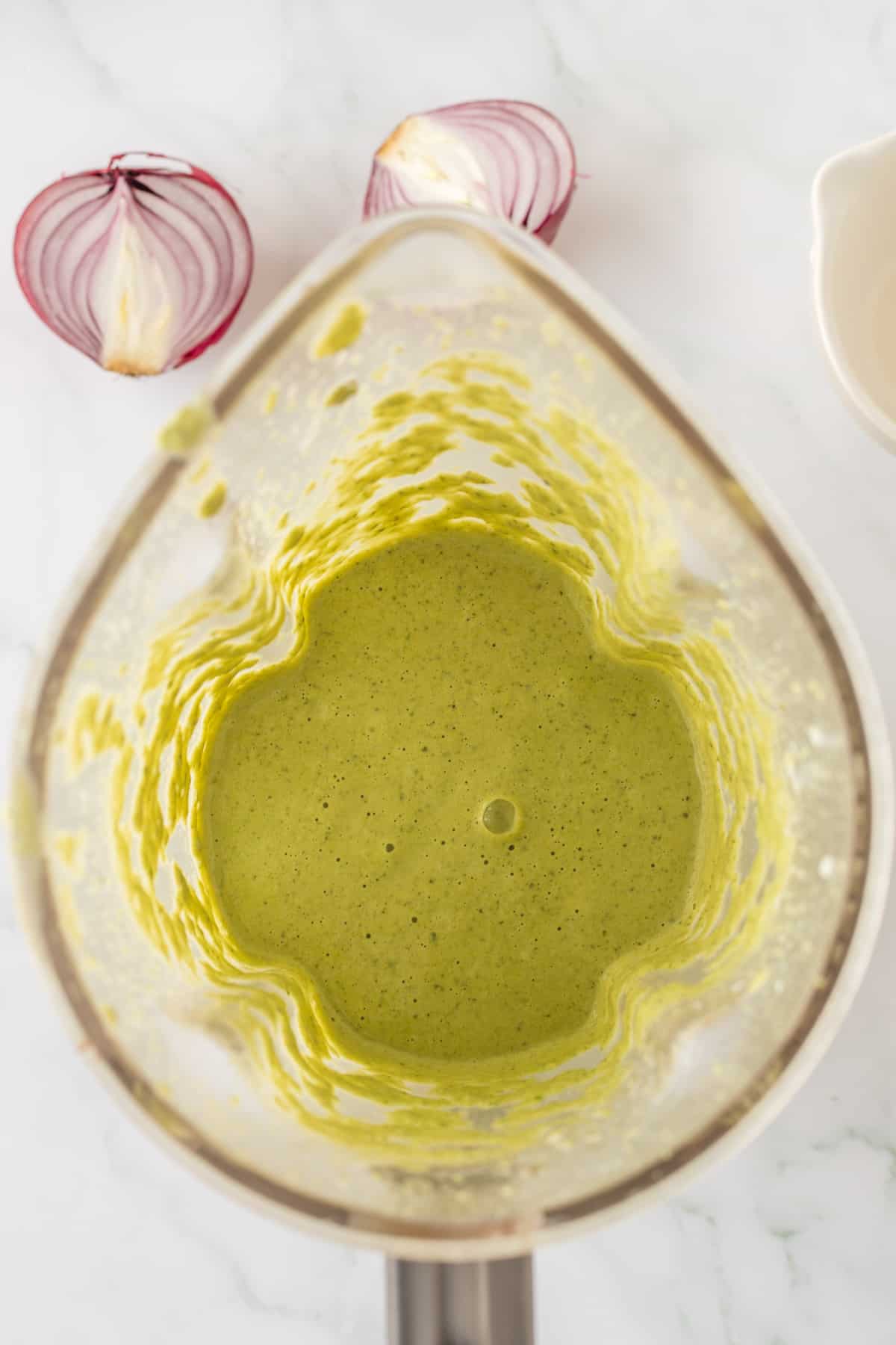 Creamy green sauce in the blender.