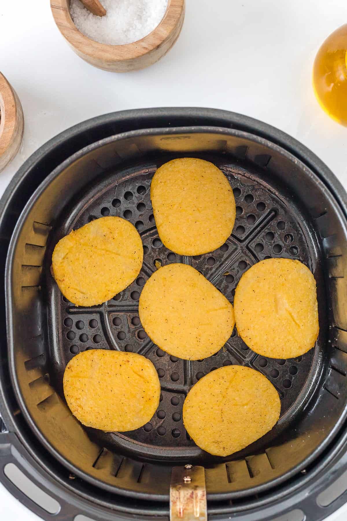 cooked polenta sliced in the basket of the air fryer