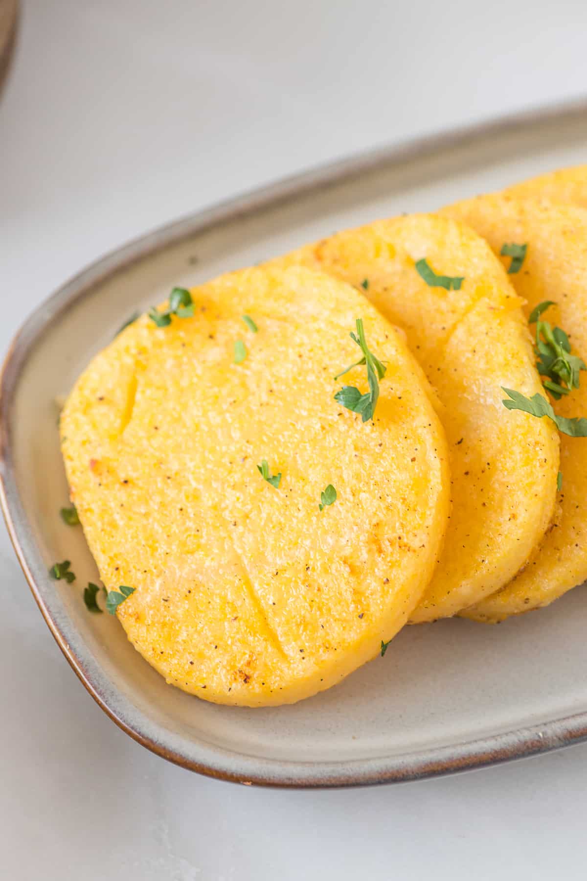 slice of polenta with chopped parsley.