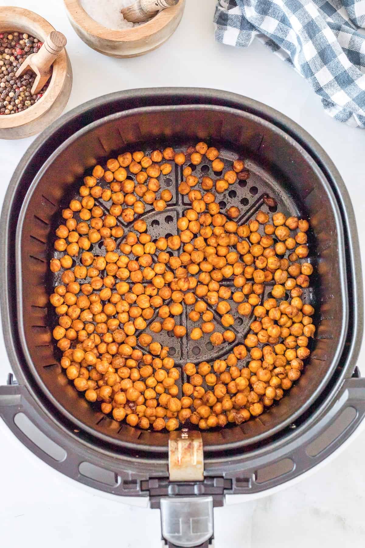 cooked chickpeas in the basket on the air fryer.