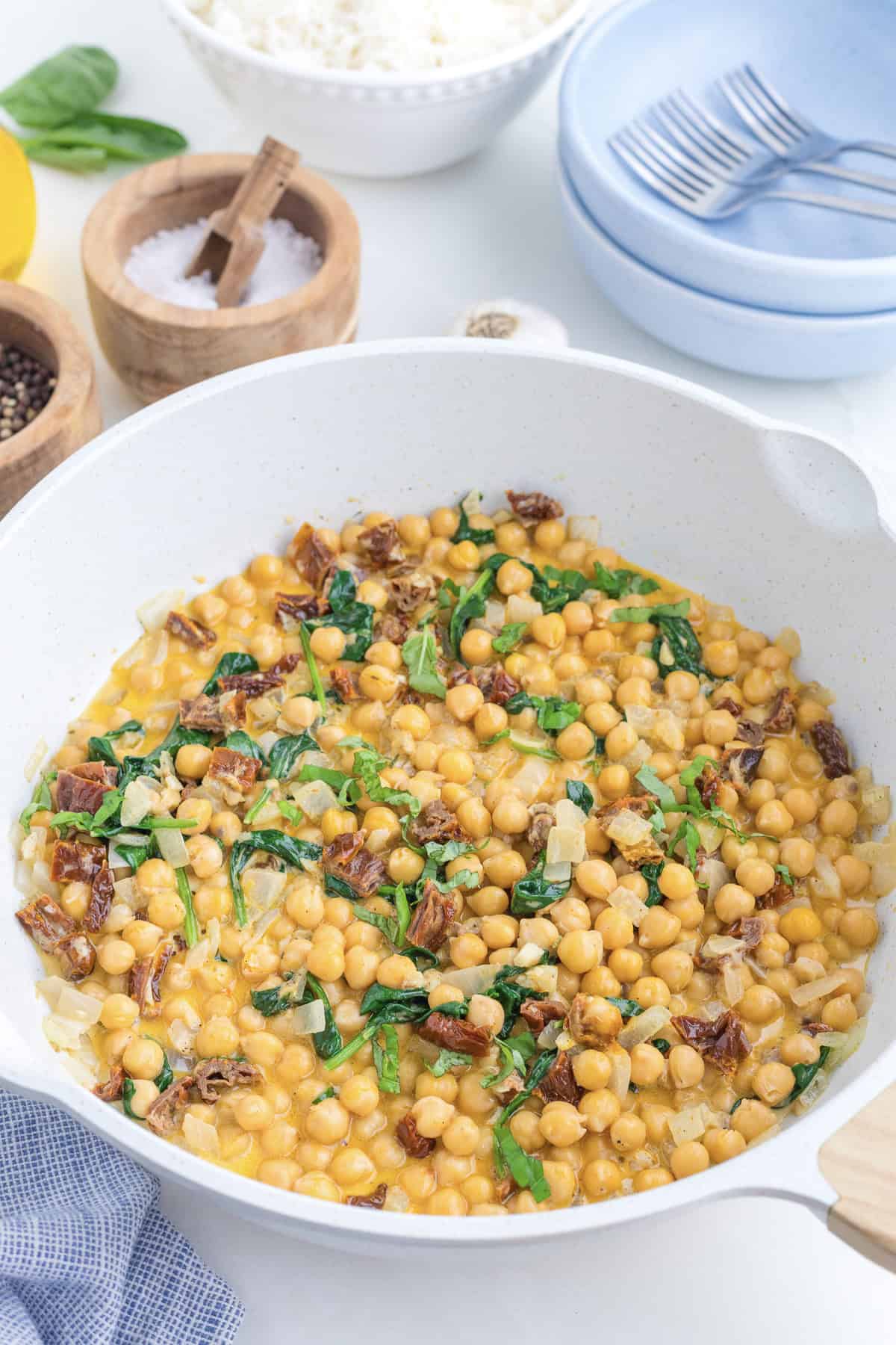 Marry me chickpeas in a white skillet.