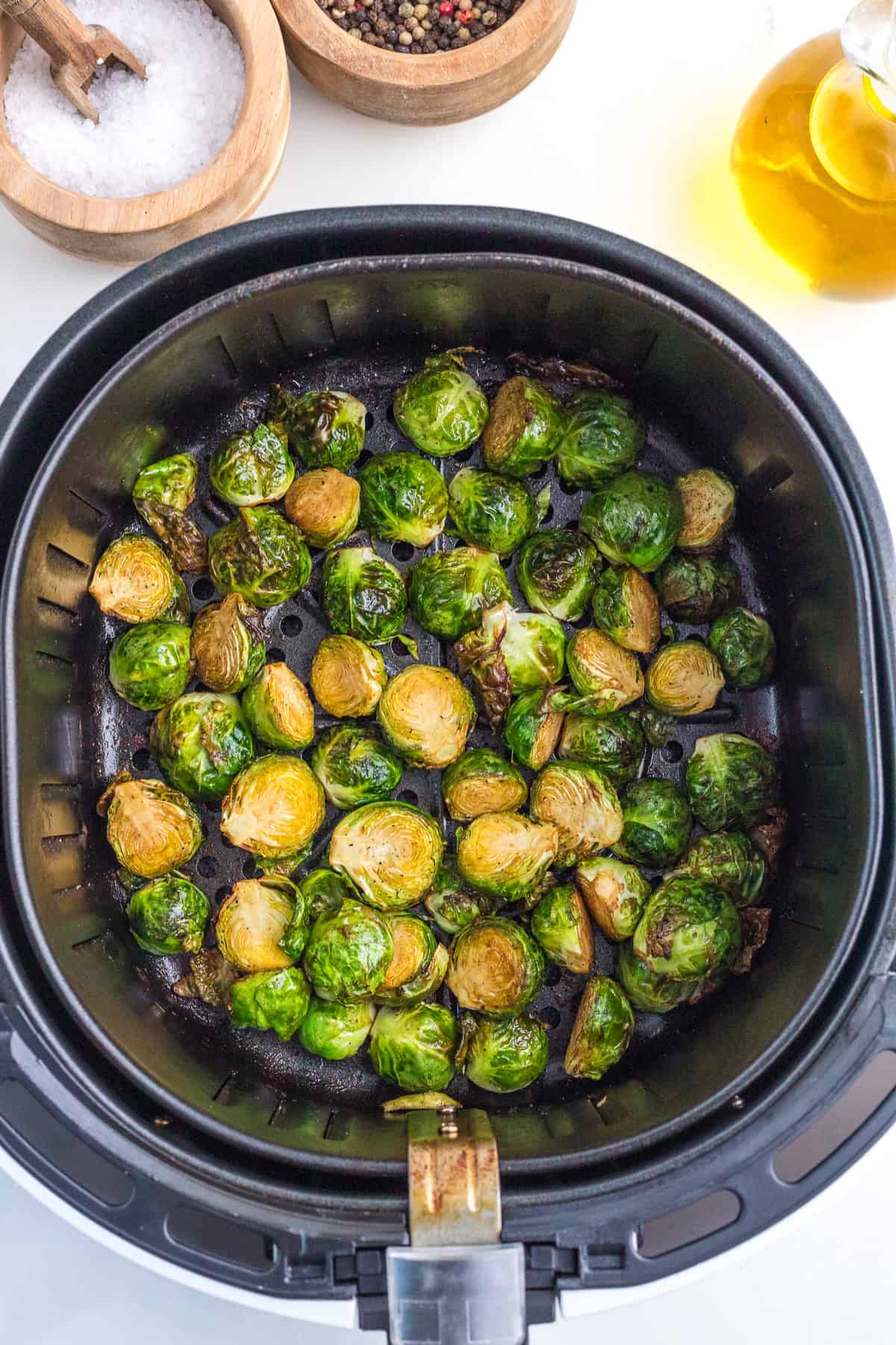 cooked Brussel sprout in the basket of the air fryer