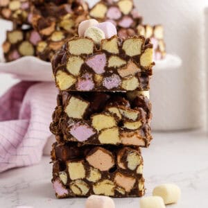Three stacked confetti square mini marshmallows inside, and loose marshmallows in the background.