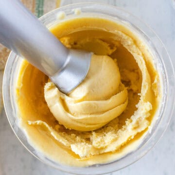 An ninja creami pean ice cream with a smooth, creamy texture inside a clear mixing bowl.